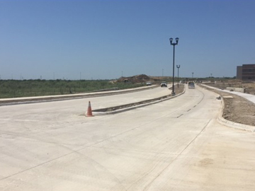 Newly extended Thompson Road looking west toward the I-35W service road 