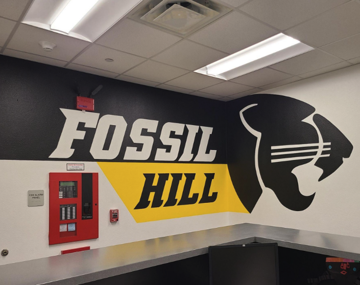 Black and gold mural of panther head and the words, "Fossil Hill" on the office wall.