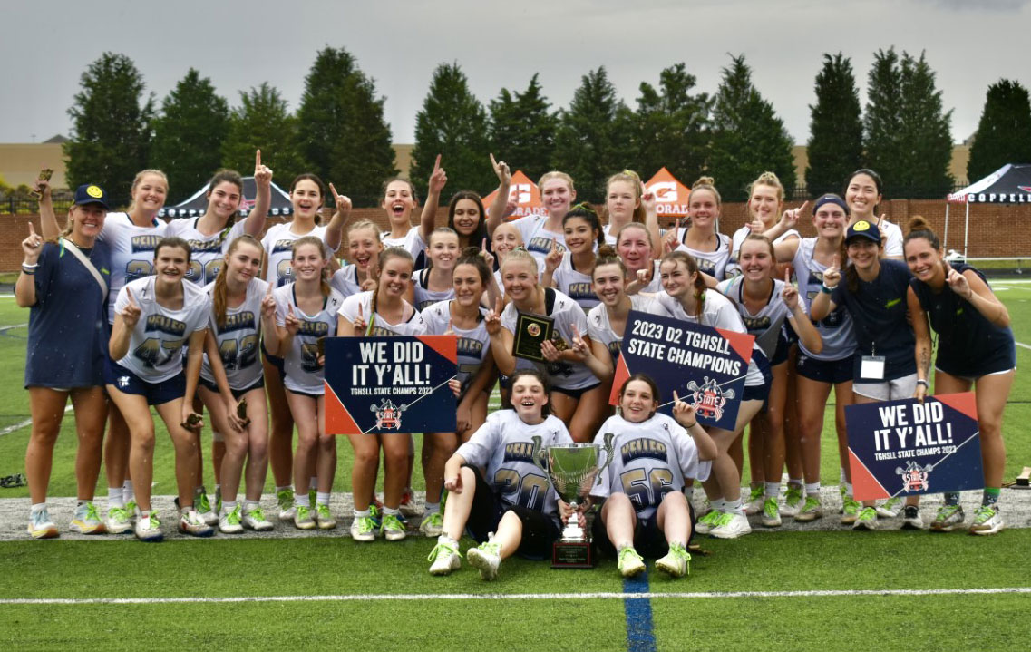 Keller Girls Lacrosse poses on the field with their state championship trophy