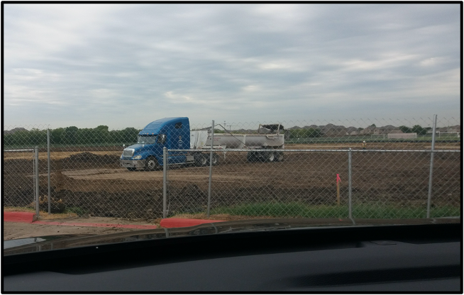 Trucks moving earth off of the new HES site 