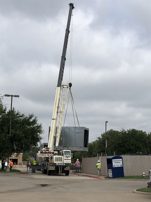 Crane lifting cooling tower into place at Keller High