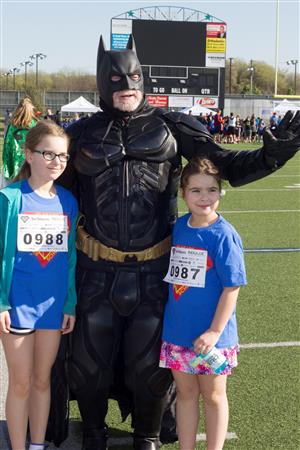 Board Trustee Jim Stitt poses with students as Batman at the KISD Diabetes Walk 