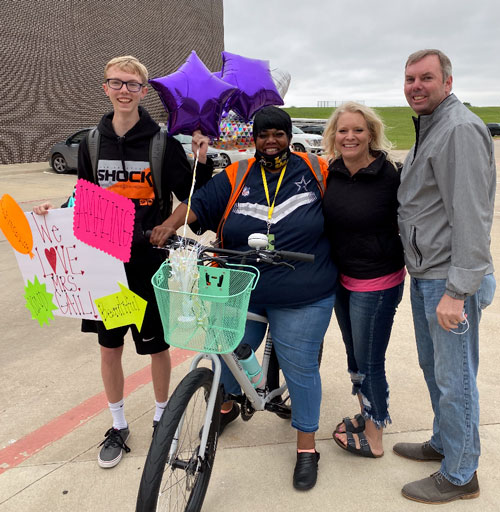 Ms. Gail with the bike, Caden, and his parents